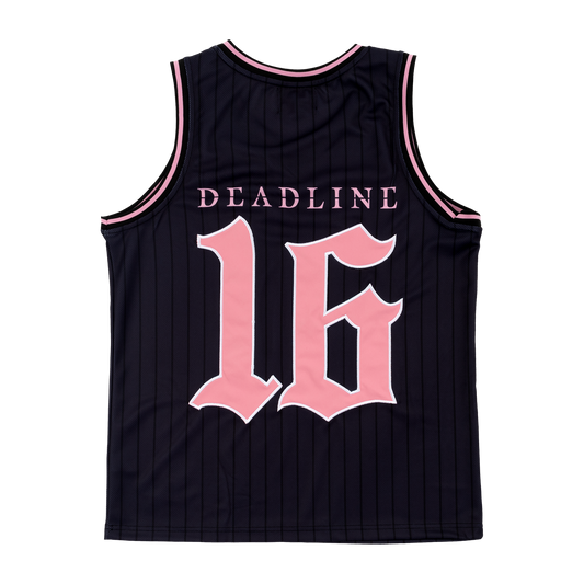 The back of a Black Jersey tank top with pink text and lettering with "Deadline" on top and on the bottom a "16" in pink with a white outline.